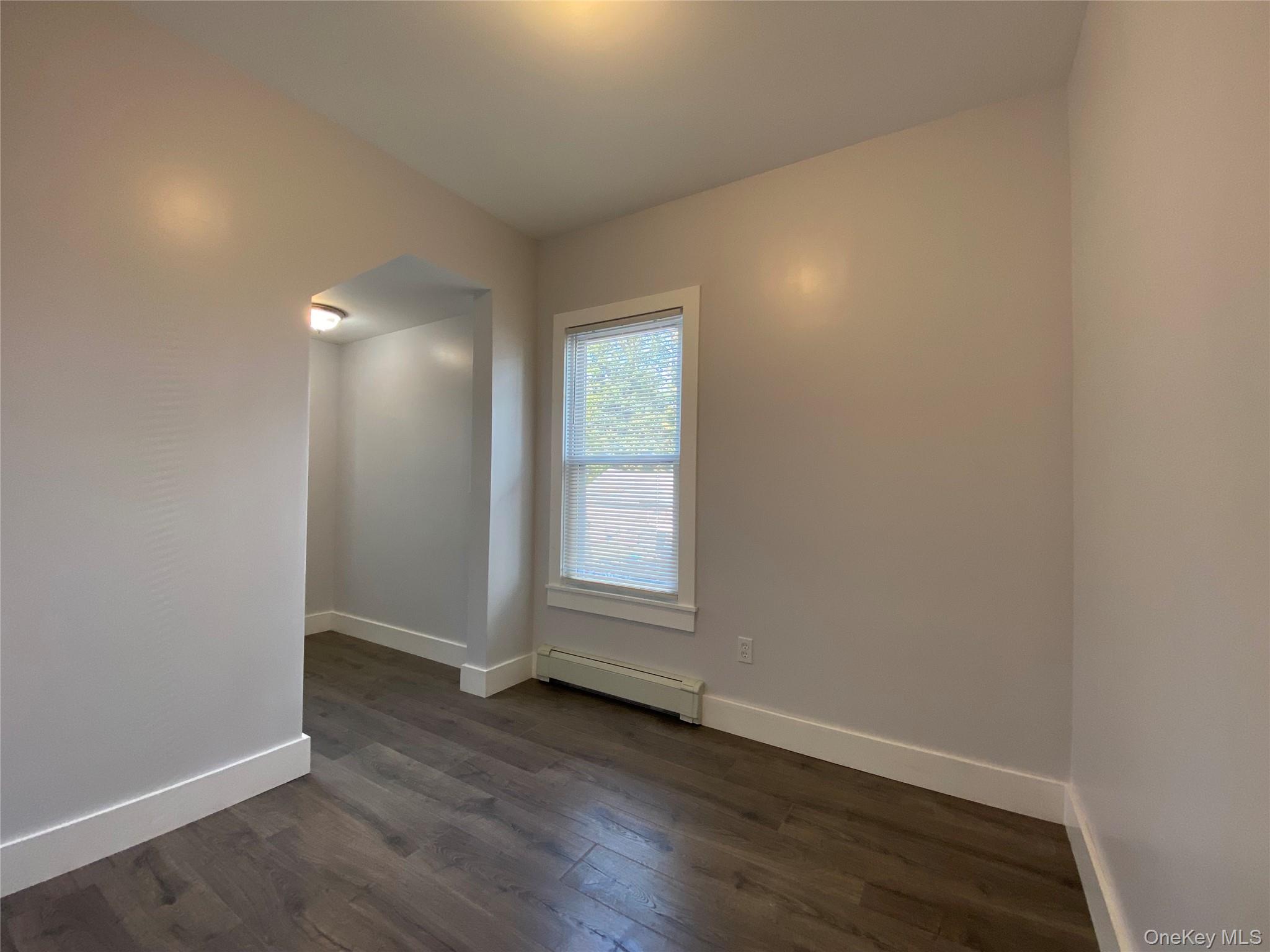 126 Garden Street Poughkeepsie, NY 12601 - Photo 7 of 13 an empty room with wooden floor and windows