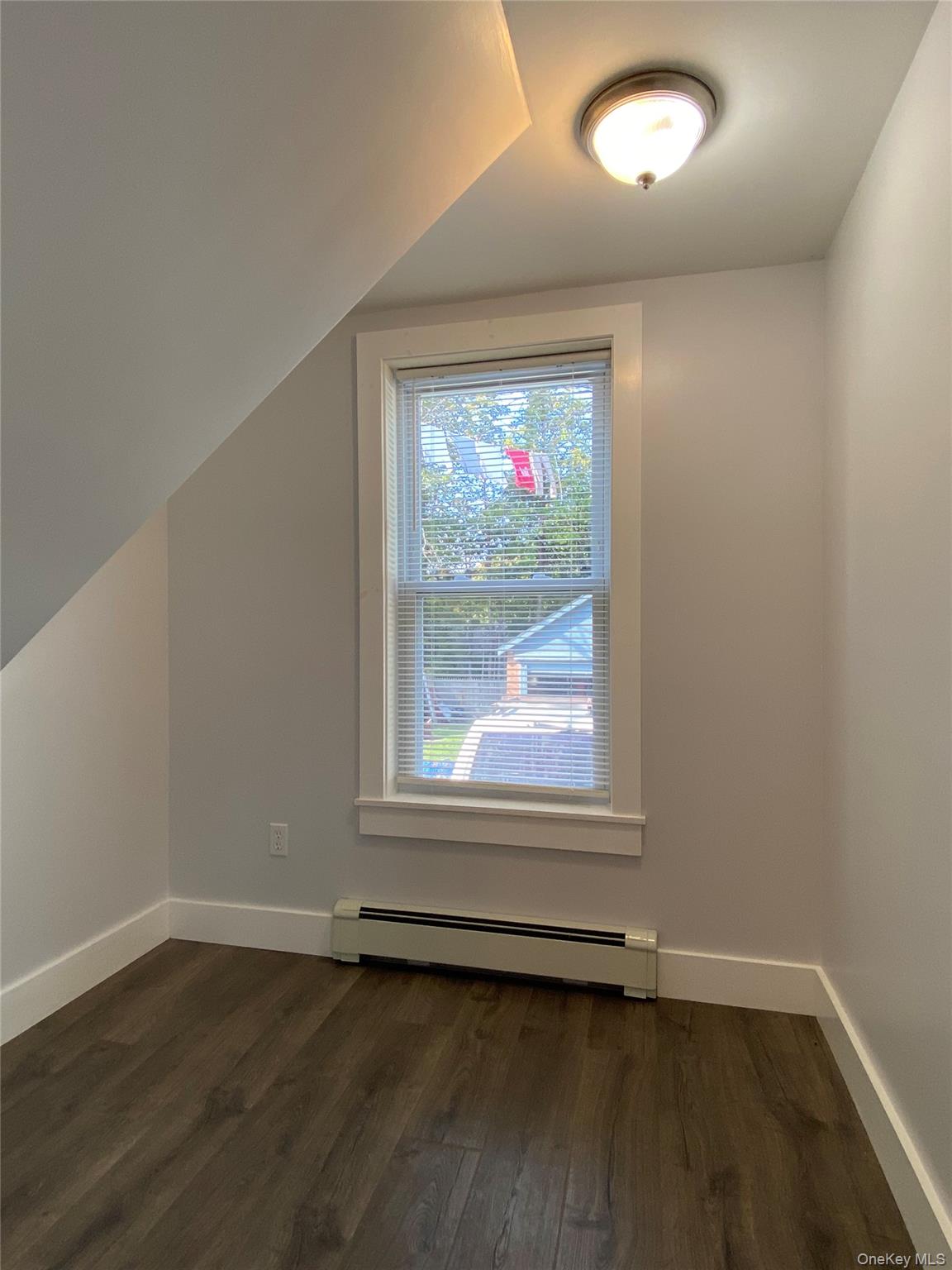 126 Garden Street Poughkeepsie, NY 12601 - Photo 8 of 13 an empty room with wooden floor and windows