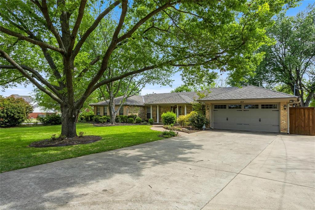 265 East Dove Road Southlake, TX 76092 - Photo 1 of 39 a yellow house in middle of the forest