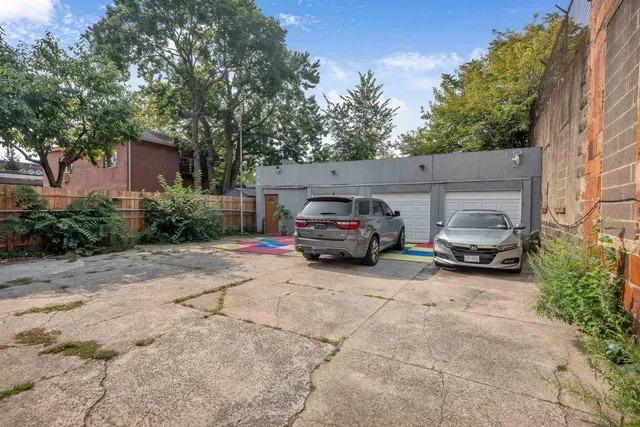a front view of a house with cars