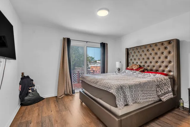 a bedroom with a bed and a large mirror