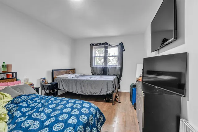 a bedroom with two beds and a television