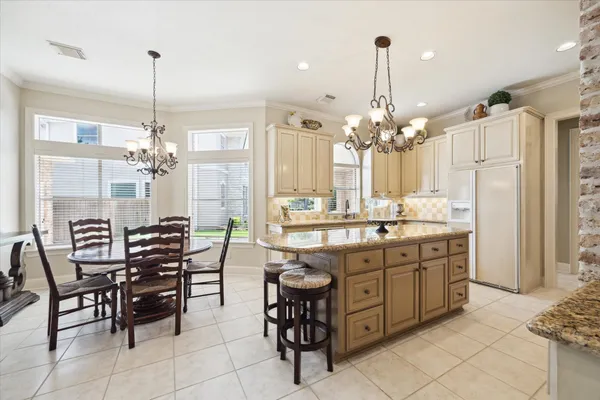 a kitchen with stainless steel appliances granite countertop a stove and cabinets