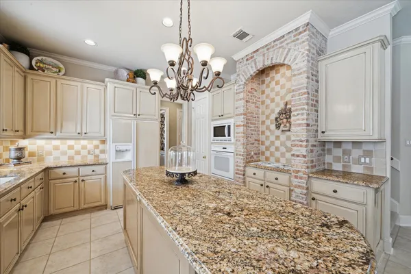 a spacious bathroom with a granite countertop sink a mirror and a bathtub