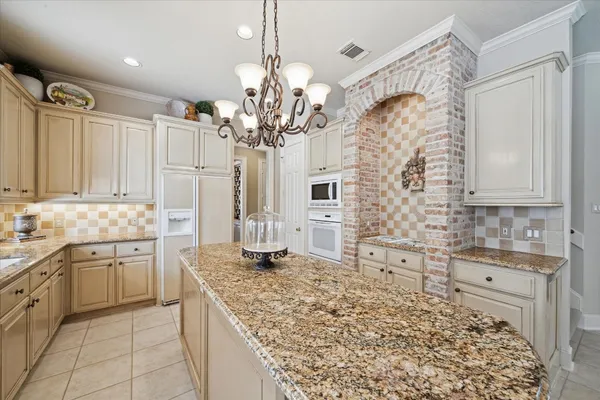a kitchen with white cabinets and white appliances