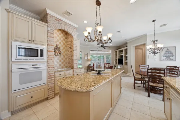 a bathroom with a toilet sink mirror and vanity