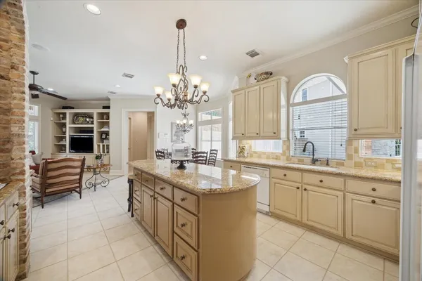 a bedroom with a bed and a lamp on the dresser