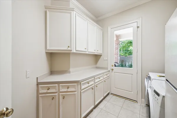 a bathroom with a toilet sink mirror and vanity