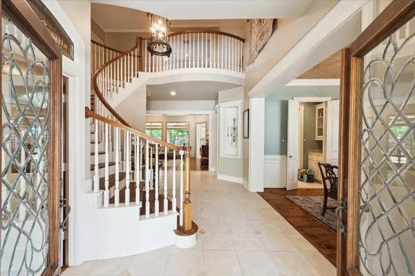 a living room with furniture and a floor to ceiling window
