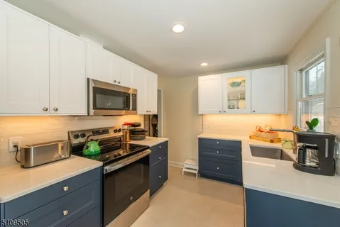 a kitchen with a stove a sink and a microwave