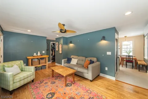 a living room with furniture and a wooden floor