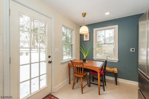 a view of a dining room with furniture and a window