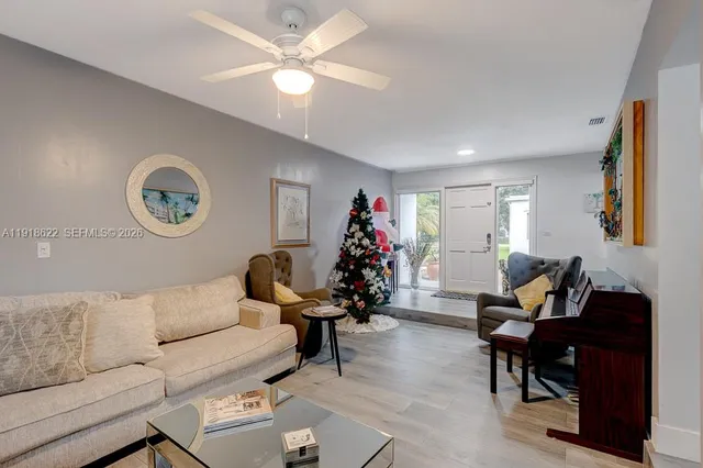 a living room with furniture and a wooden floor