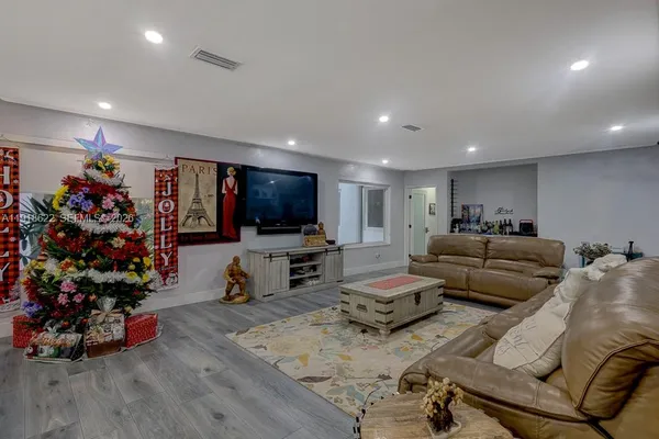 a living room with furniture gym equipment and a large window