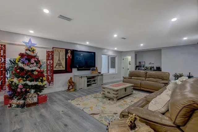 a living room with furniture gym equipment and a large window