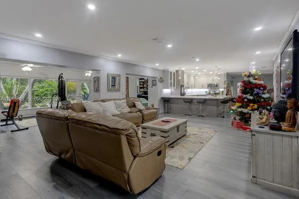 a living room with furniture gym equipment and a large window