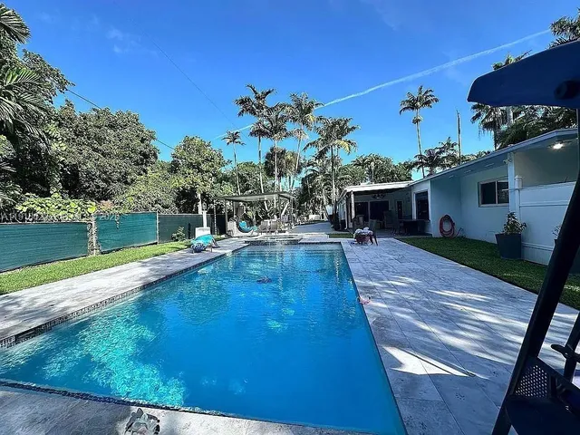 a view of swimming pool with chairs
