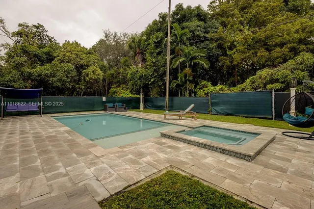 a view of a backyard with large trees