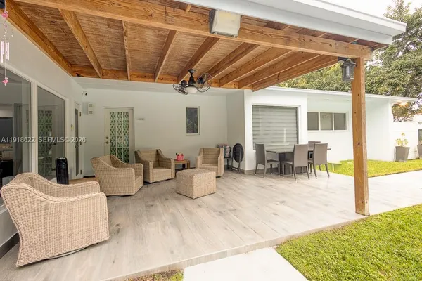 a view of a backyard with plants and patio
