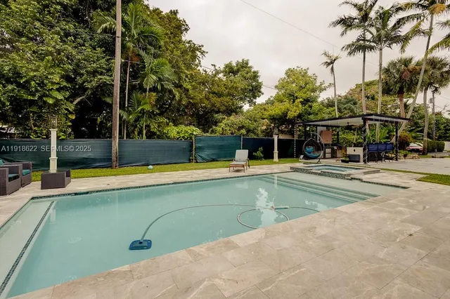 a view of an chairs room with large trees