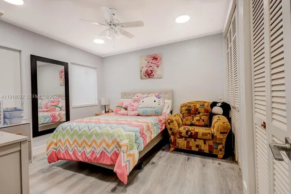 a bedroom with a bed window and furniture