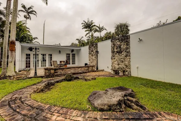 a kitchen with stainless steel appliances granite countertop a refrigerator a stove and a sink