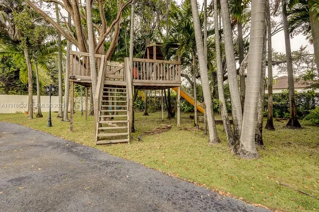 a bathroom with a granite countertop sink and a washing machine
