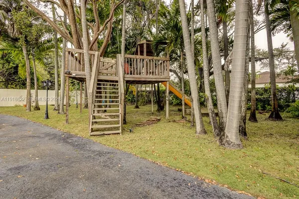 a bathroom with a granite countertop sink and a washing machine