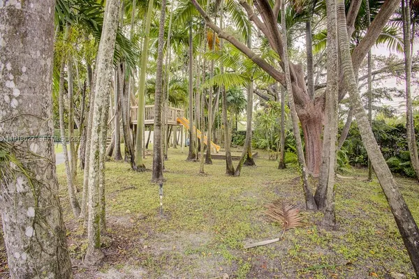 an aerial view of residential houses with yard