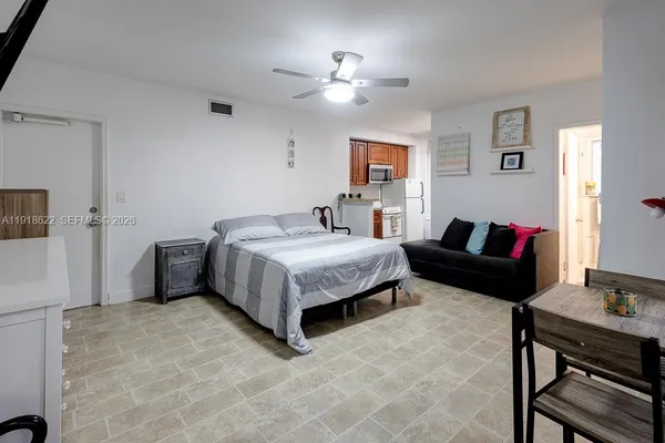 a backyard of a house with a yard and large trees