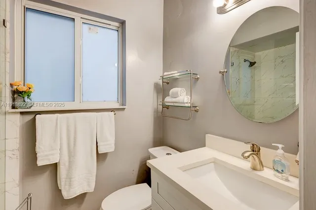 a view of a garden with a bench under an umbrella