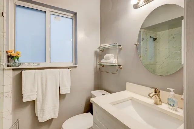 a view of a garden with a bench under an umbrella