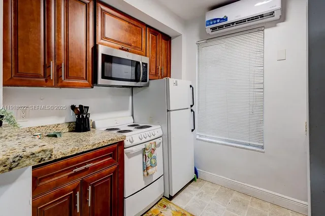 an aerial view of a house with a yard and large trees