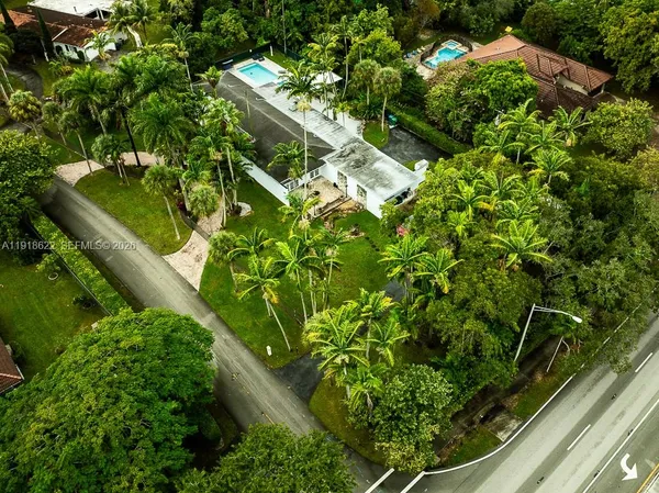 an aerial view of residential houses with outdoor space and street view