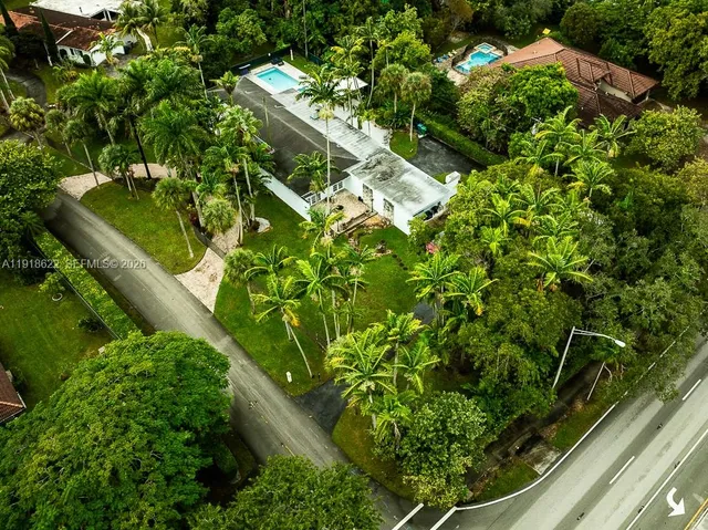 an aerial view of residential houses with outdoor space and street view