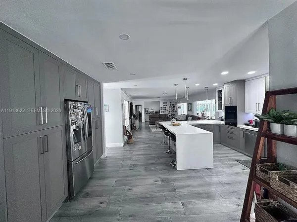 a kitchen with a sink a table and chairs