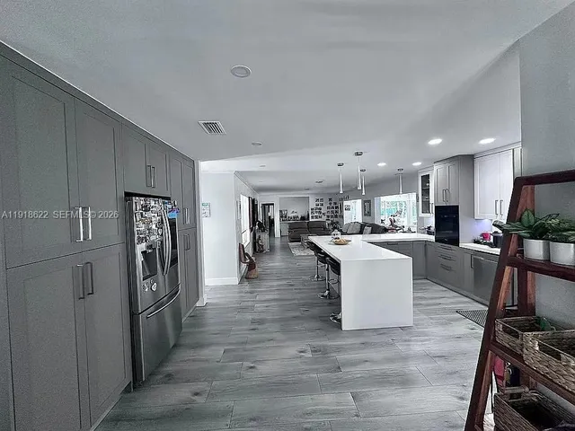 a kitchen with a sink a table and chairs