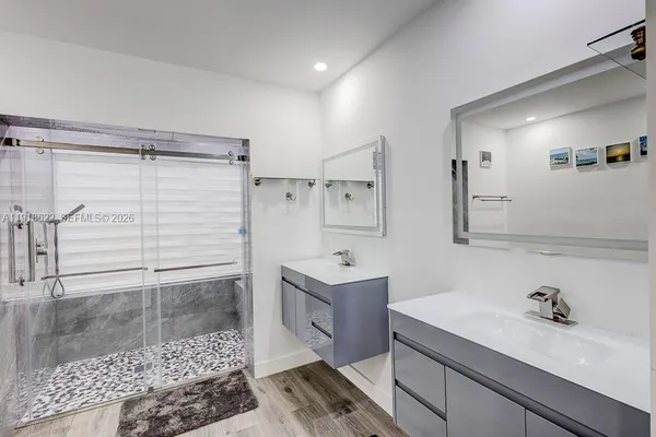 a spacious bathroom with a toilet sink and mirror