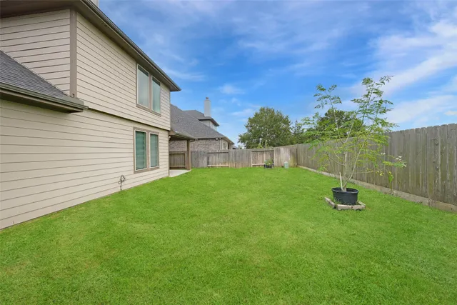 a view of garden with tall house