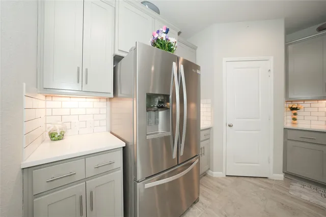 a kitchen with stainless steel appliances kitchen island a white stove top oven and wooden cabinets