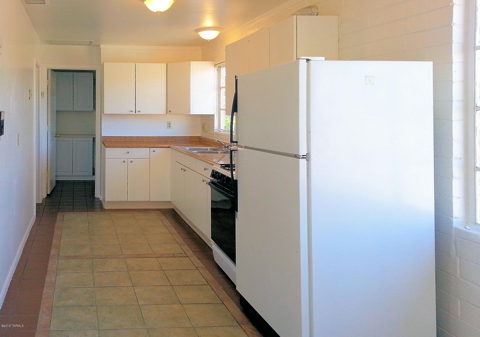131 West Navajo Road Tucson, AZ 85705 - Photo 3 of 13 a kitchen with a refrigerator and a stove