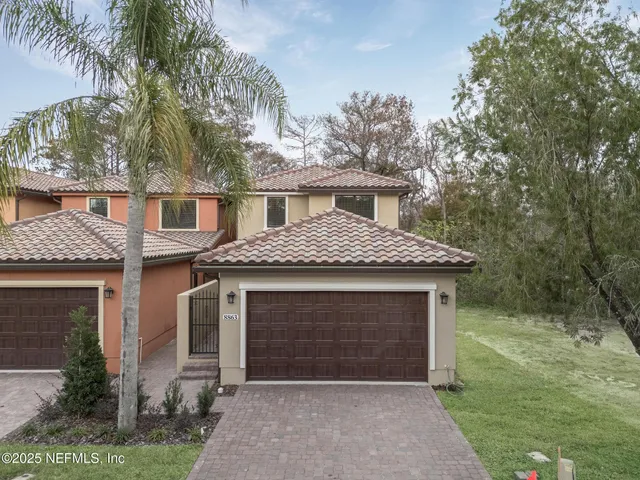 a view of a hallway with wooden floor and entryway