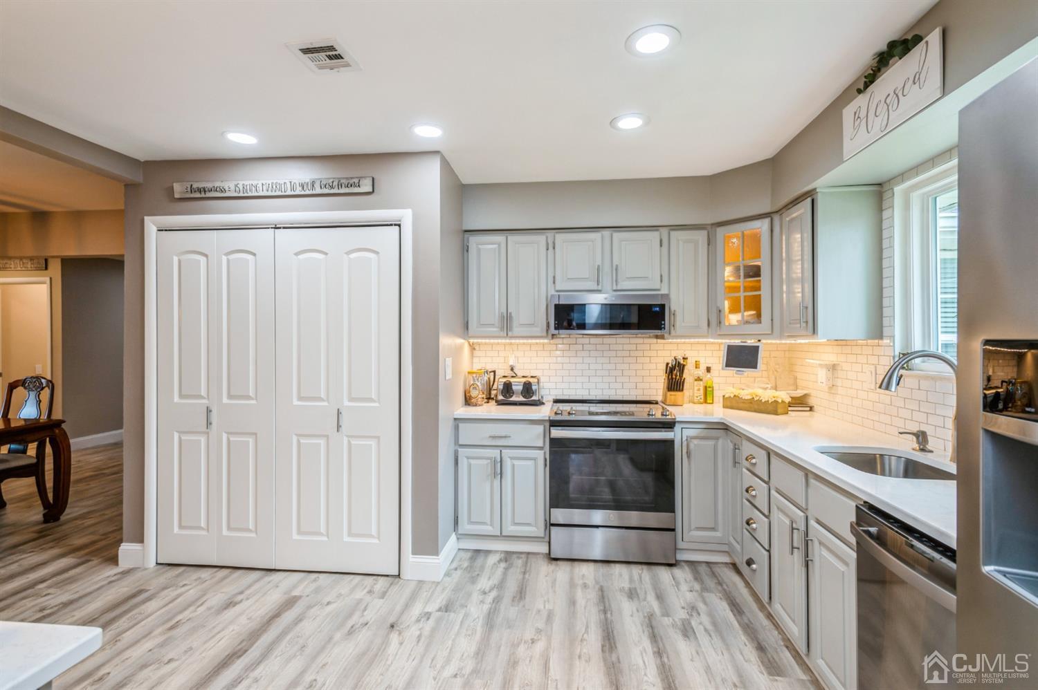 735 Prospect Road, Unit A Monroe Township, NJ 08831 - Photo 9 of 20 a kitchen with stainless steel appliances granite countertop a stove and a sink