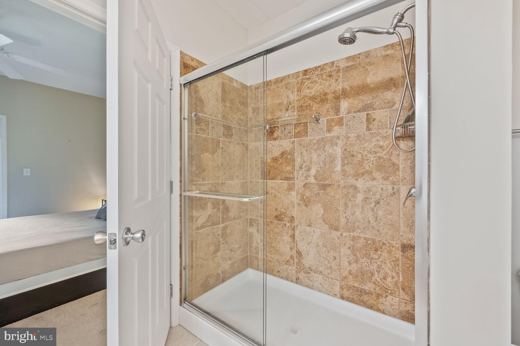 7 Booth Street, Unit 202 Gaithersburg, MD 20878 - Photo 11 of 32 a bathroom with a glass shower door