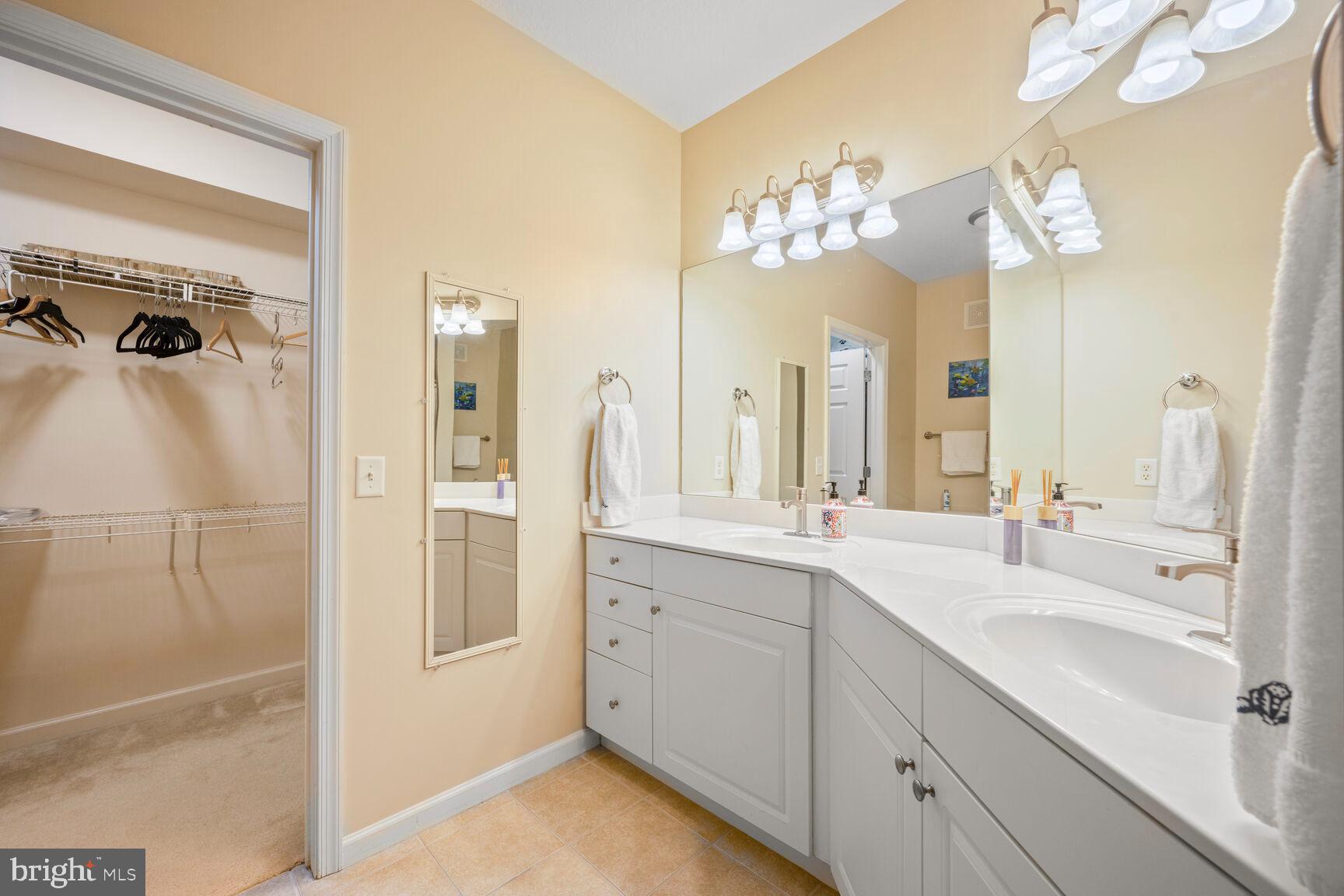 7 Booth Street, Unit 202 Gaithersburg, MD 20878 - Photo 12 of 32 a bathroom with a double vanity sink mirror and shower