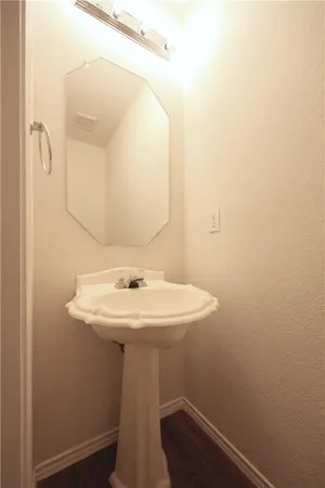 a bathroom with a sink a mirror and shower