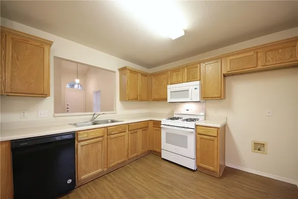 a kitchen with stainless steel appliances granite countertop a sink and cabinets