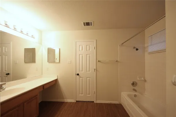 a bathroom with a sink a toilet a shower and a mirror