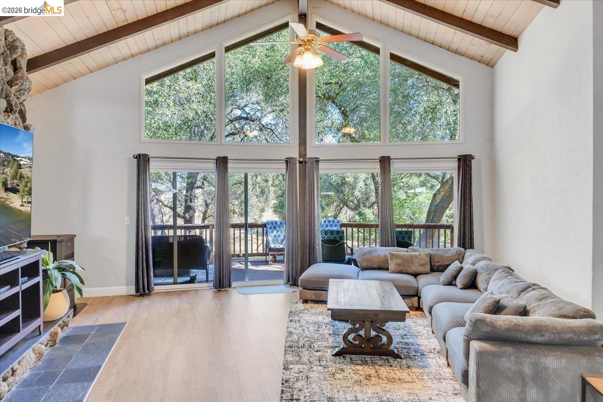 8733 Fraguero Road Sonora, CA 95370 - Photo 22 of 73 Vaulted wood-paneled ceilings with exposed beams complement the stone-faced fireplace surround