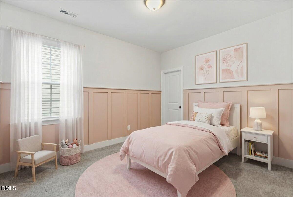 4937 Abundance Avenue Raleigh, NC 27616 - Photo 23 of 36 a bedroom with a bed and a couch